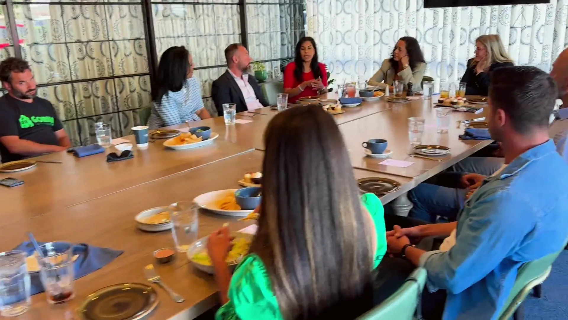 A rotating montage of Lunch with Leaders gatherings: members in candid conversation across several rooms