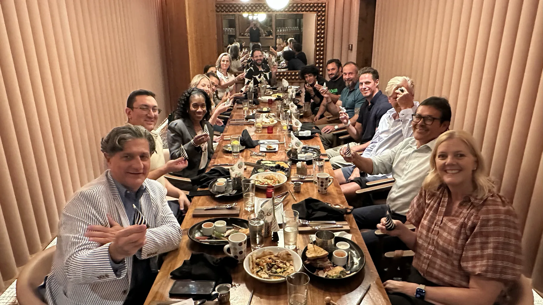 A large group of Impact Delivered members celebrating together at a gathering